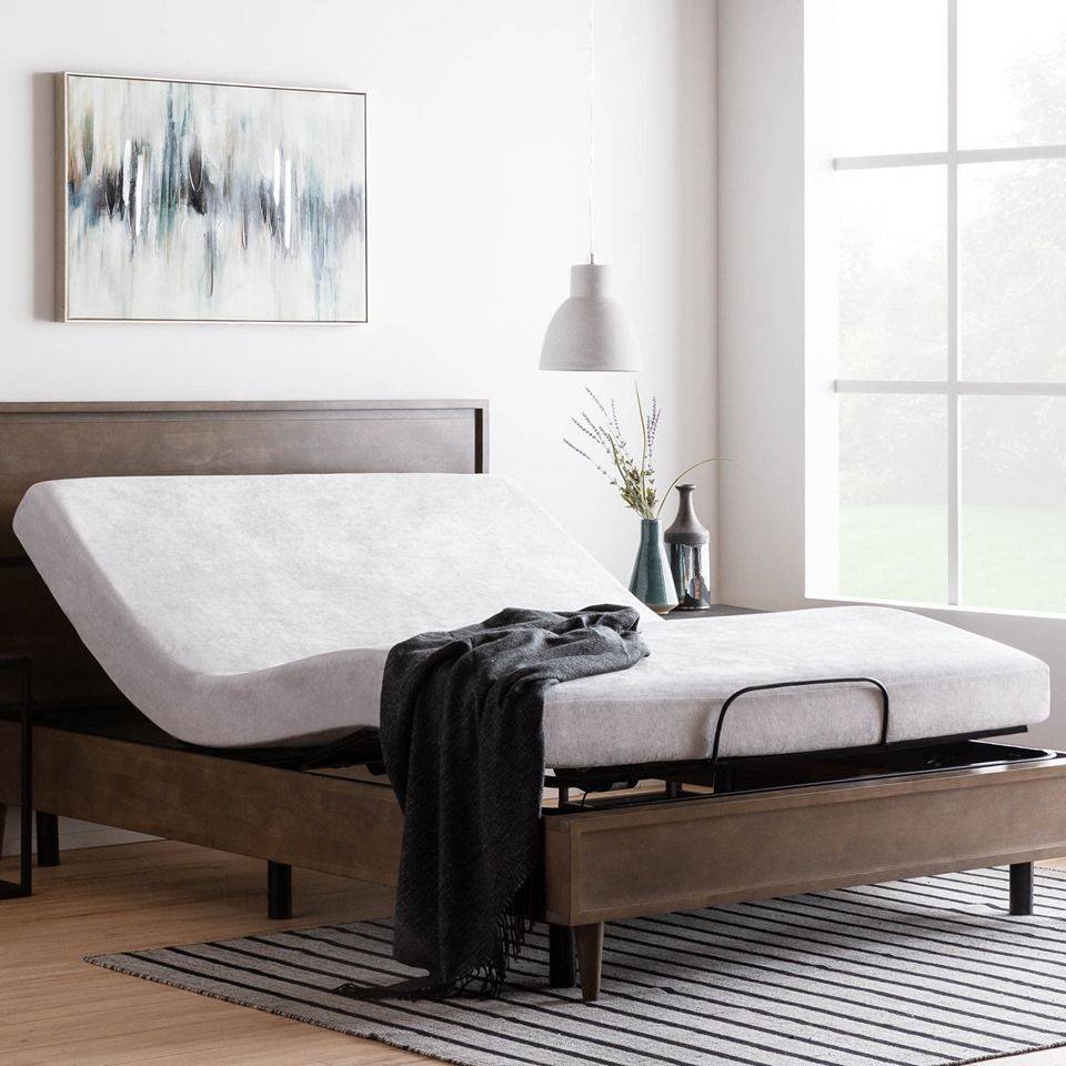 Adjustable bed base with the head section raised, in a bright bedroom